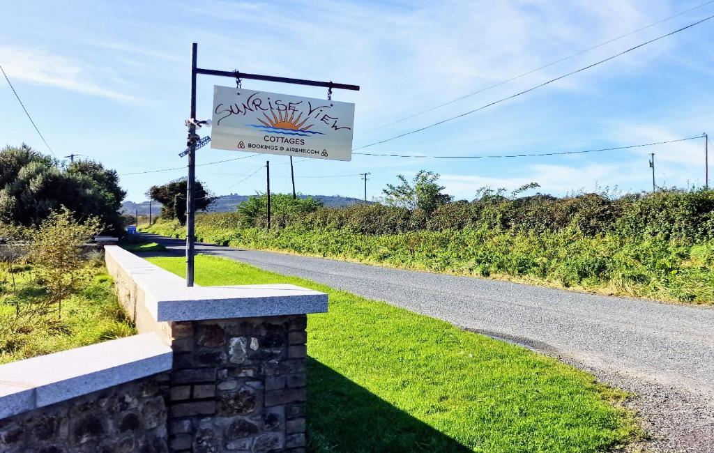a sign on the side of a road at Sunriseview Cottages in Wicklow