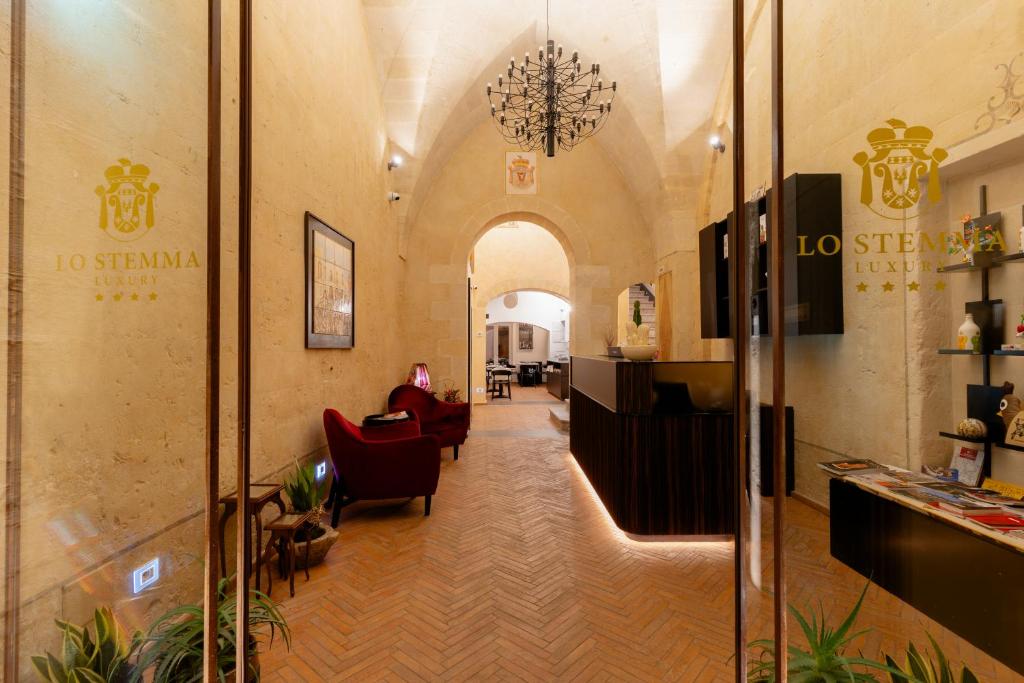 a lobby of a building with a person sitting in a chair at Lo Stemma Luxury Boutique Hotel in Matera
