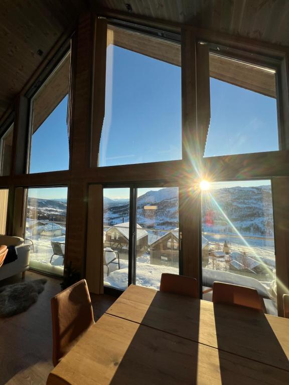 a dining room with a table and a large window at Rindabotten Panorama in Sogndal
