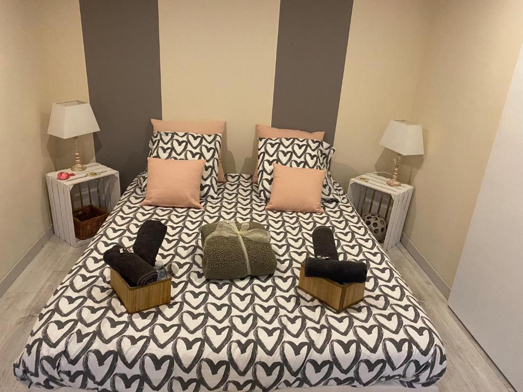 una camera da letto con un letto con cuscini e due tavoli di Séverine chambres d’hôtes a Floing