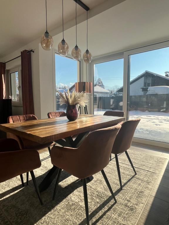 a dining room with a wooden table and chairs at Luxurious apartment with garden in Prien am Chiemsee