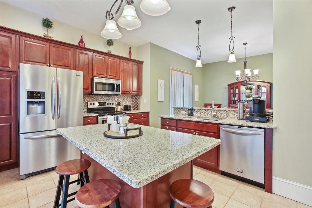 a kitchen with stainless steel appliances and wooden cabinets at Greenridge Getaway:Near Universities & Attractions in Scranton