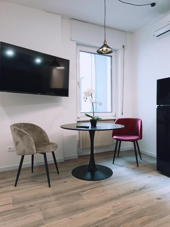 a dining room with a table and two chairs at Apartment Teatro in Bolzano