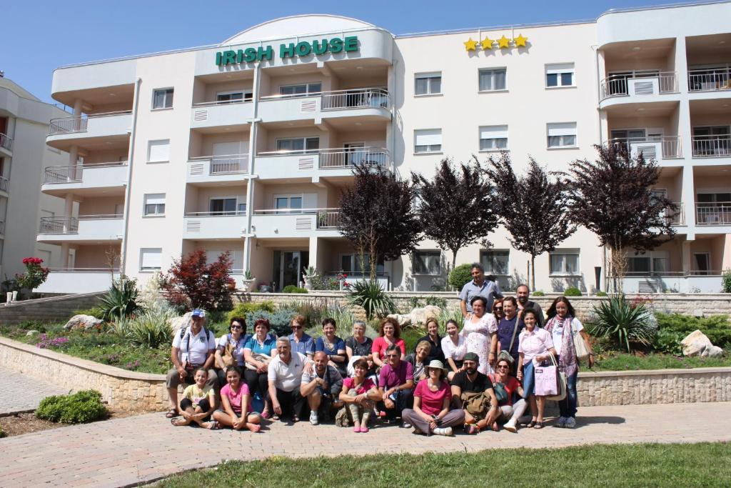 a group of people posing for a picture in front of a building at Irish House Međugorje in Međugorje