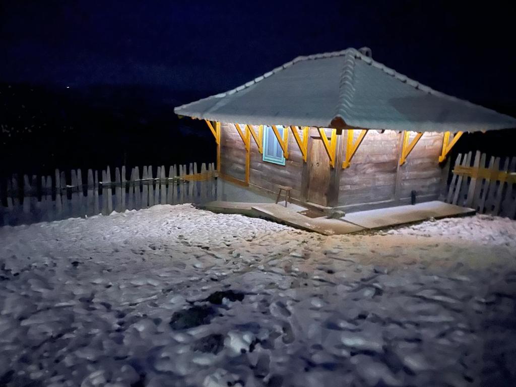 a gazebo in the snow at night at Etno Selo Rajski Konaci in Leušići