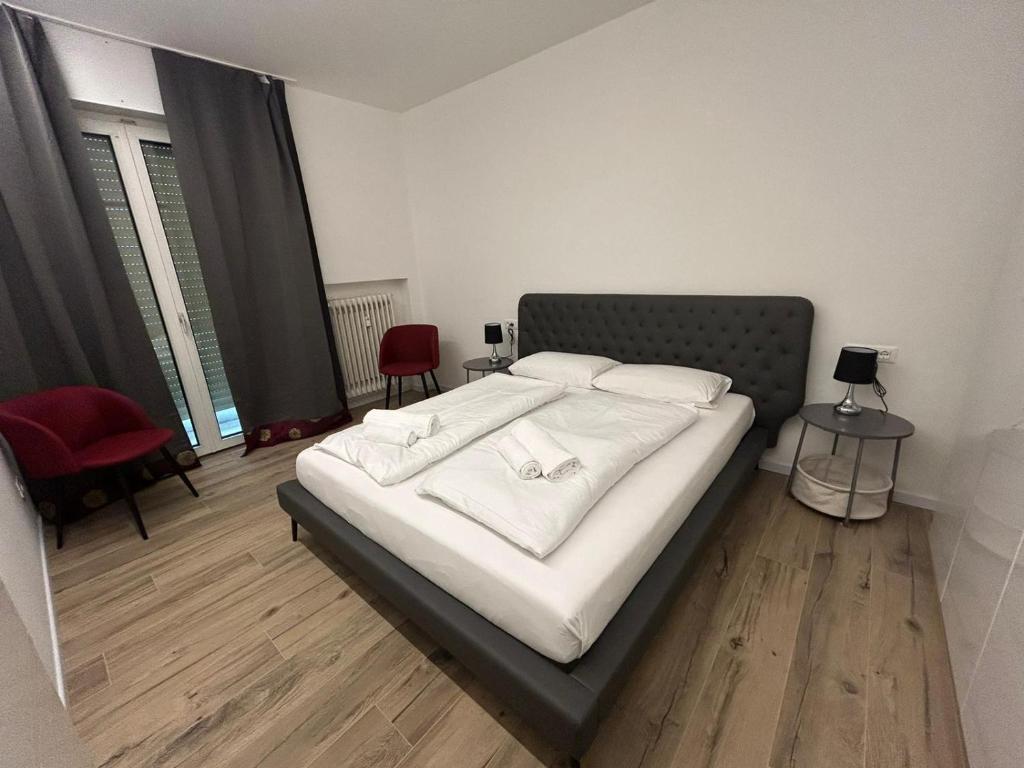 a bedroom with a bed with white pillows on it at Luxury Apartment Teatro in Bolzano