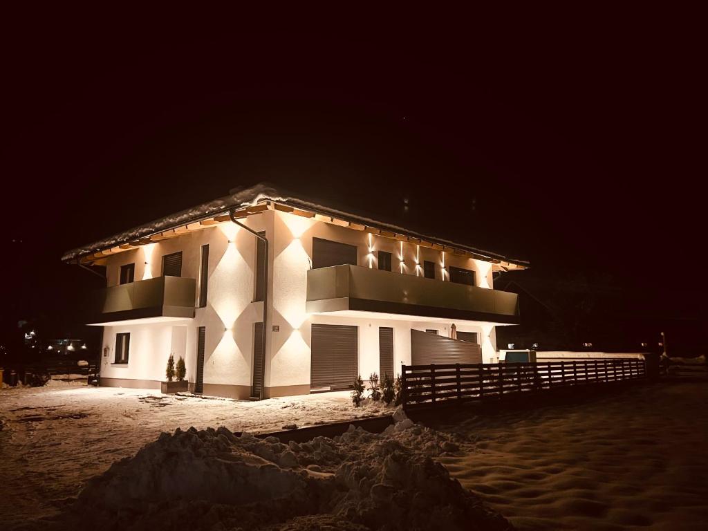 a large building with lights on it at night at Alpin Apartments in Radstadt