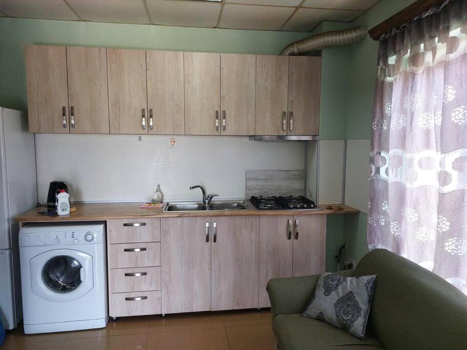 a kitchen with a sink and a washing machine at Wonderful_place_for 2 persons in Tbilisi City