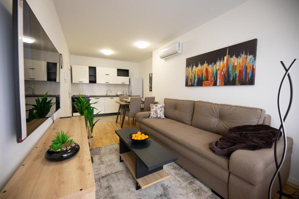 a living room with a couch and a table at Apartman IVANA - private parking in Osijek