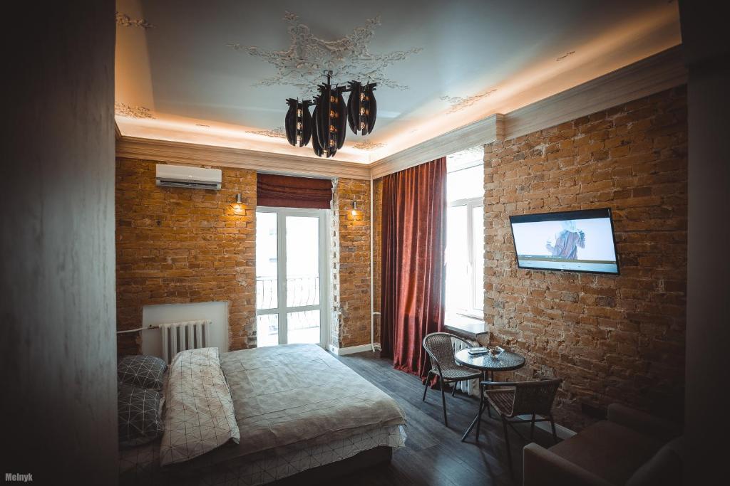 a bedroom with a bed and a brick wall at Olympic studio in Kyiv