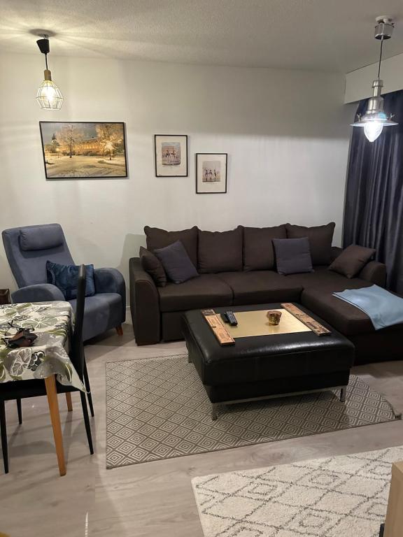 a living room with a couch and a table at Villa Haantie in Längelmäki