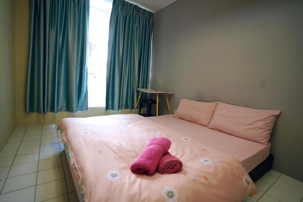 Postel nebo postele na pokoji v ubytování Swanling Kuching