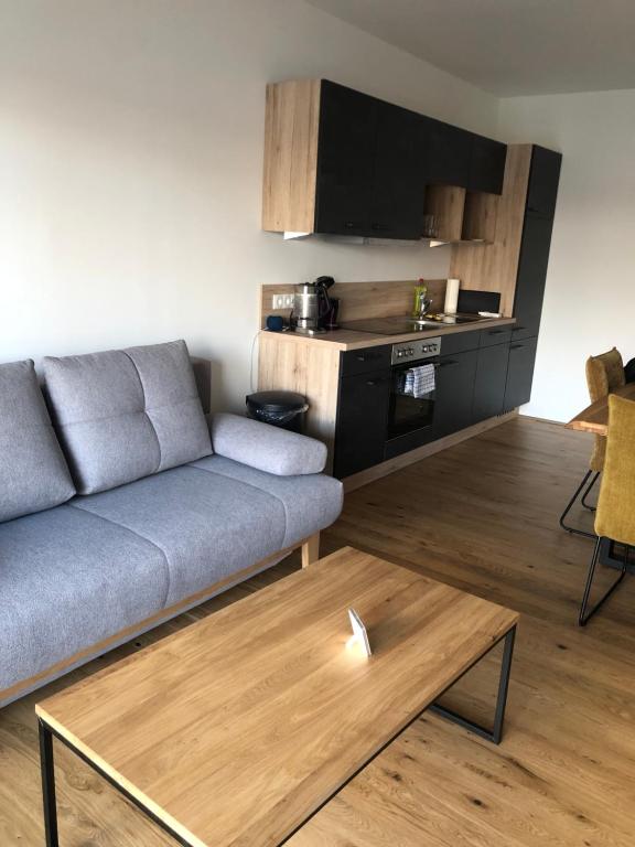 a living room with a couch and a table at Studentenwohnung in Grafenwörth
