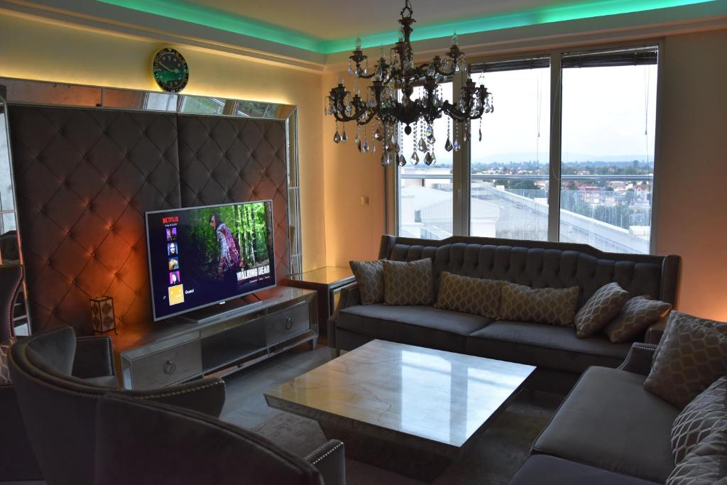 a living room with a couch and a tv at Luxury apartment in Skopje in Skopje