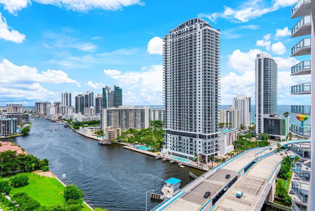 a view of a city with a river and buildings at Water View Building With Pool - 5-Min Walk To The Beach in Hallandale Beach