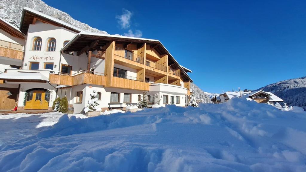 a large pile of snow in front of a building at Alpenspitz Appartements - Garni - B&B in Racines