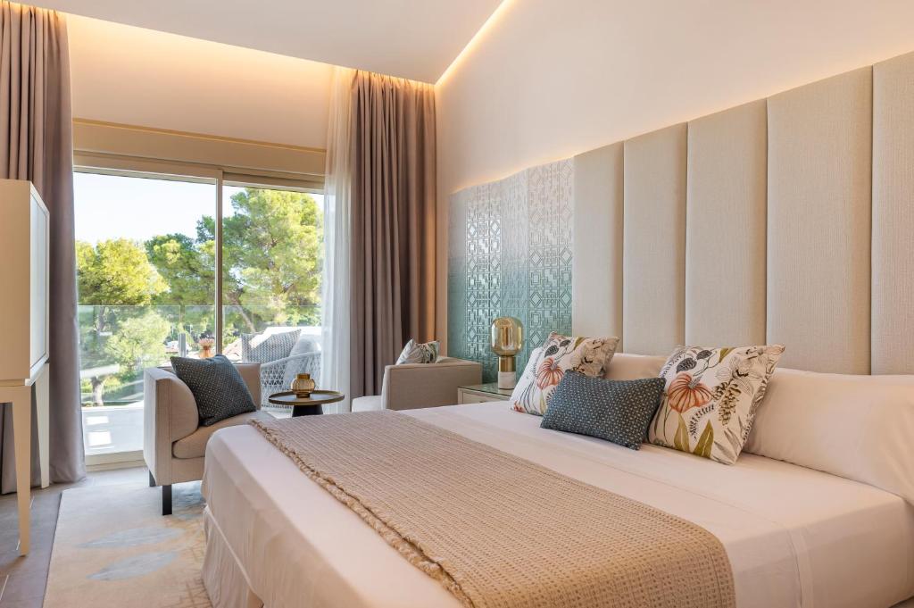 a bedroom with a large bed and a large window at Dionis Boutique Hotel & Spa in Jávea