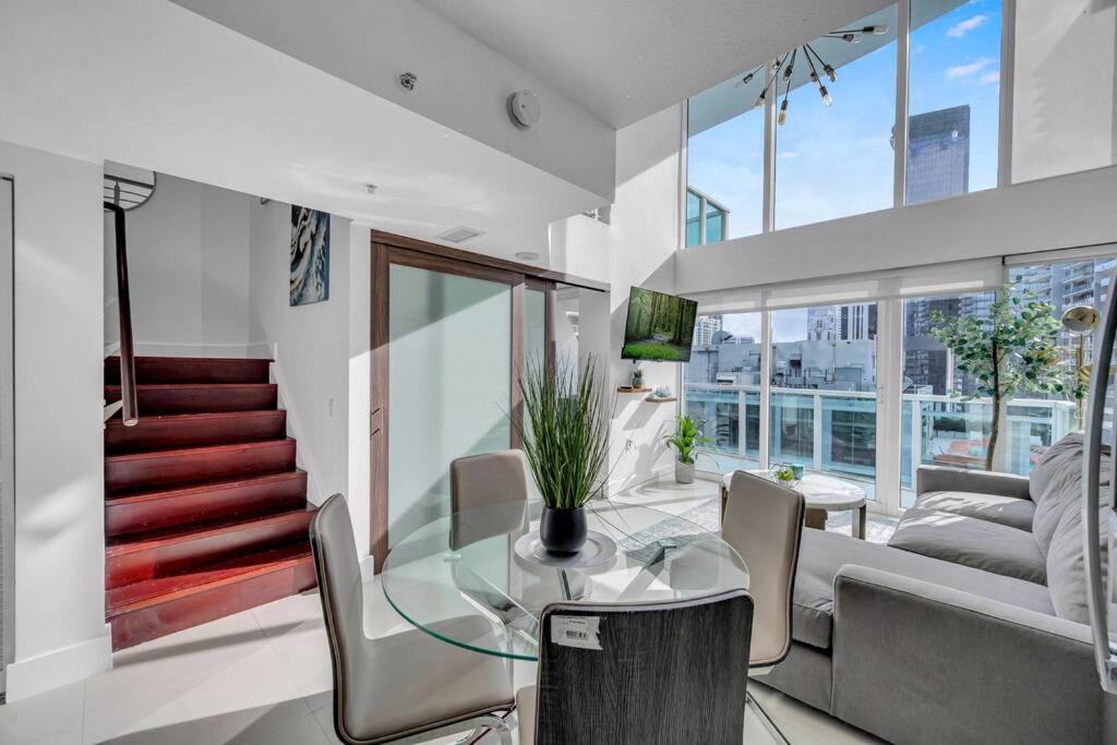 a living room with a glass table and a couch at Luxury 2 Bedroom Loft Brickell-WaterViews in Miami