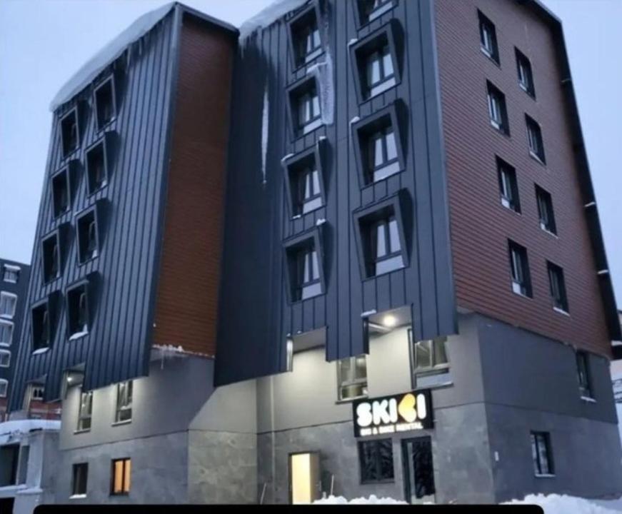 a building with a sign on the side of it at Sky Lux Apartments in Jahorina