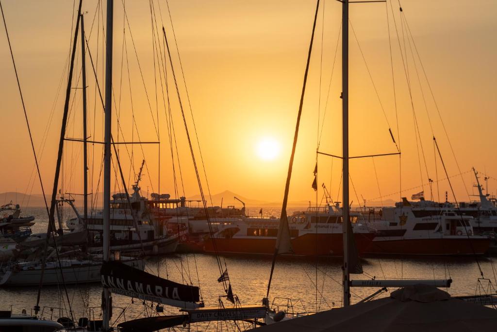 a group of boats docked in a harbor at sunset at Casa di Grazia in Naxos Chora