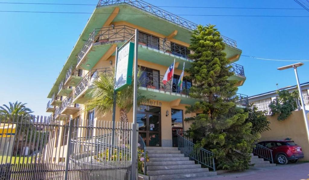 a building with a staircase in front of it at Hotel Rocas del Pacifico in Pichilemu