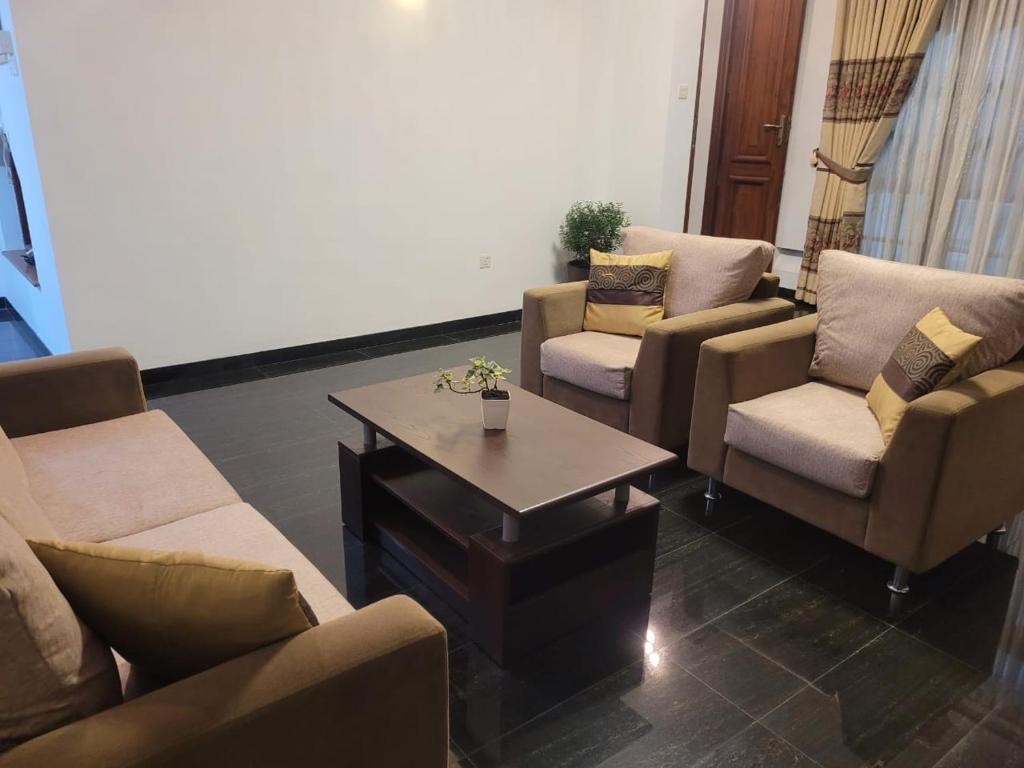 a living room with couches and a coffee table at M-stay Colombo in Sri Jayewardenepura Kotte