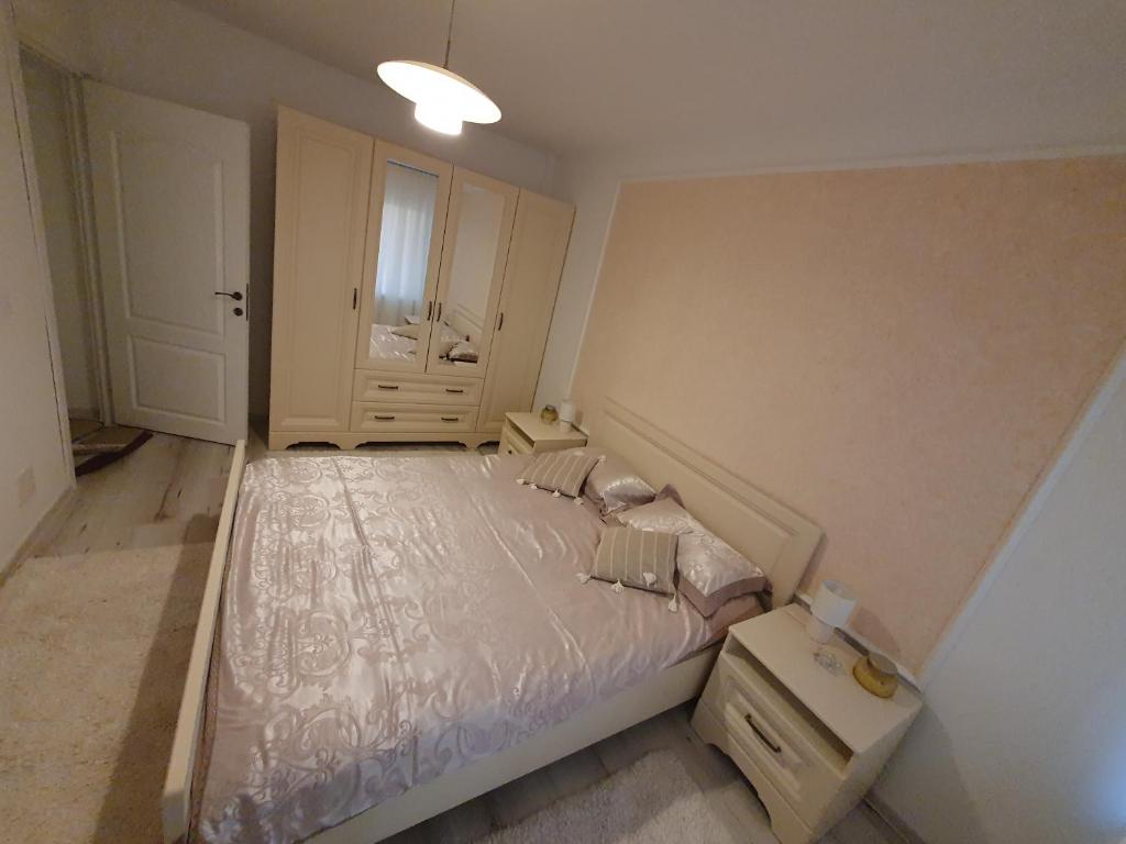 1 dormitorio con cama blanca y ventana en Suceava apartment, en Suceava