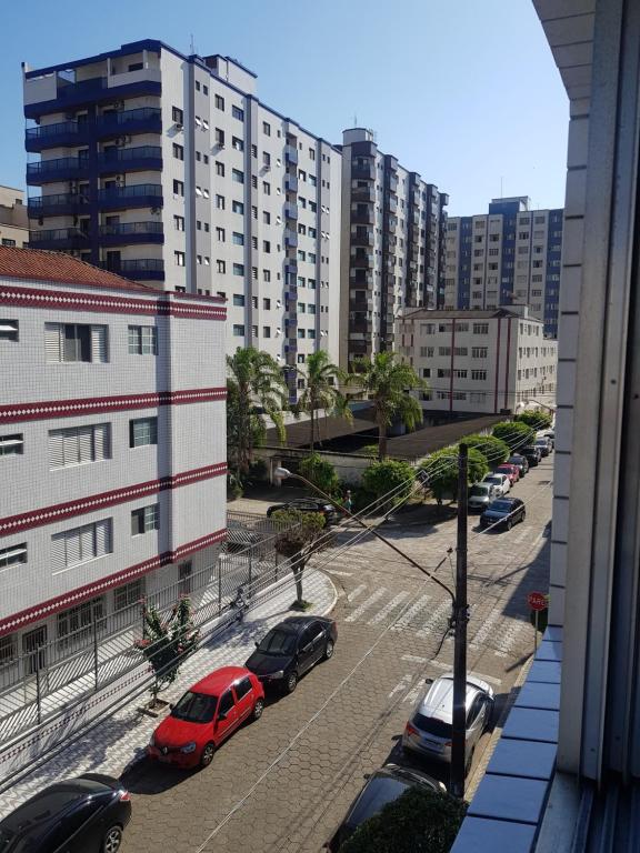 een uitzicht op auto's geparkeerd op een parkeerplaats met gebouwen bij Apartamento Perto da Praia in Praia Grande