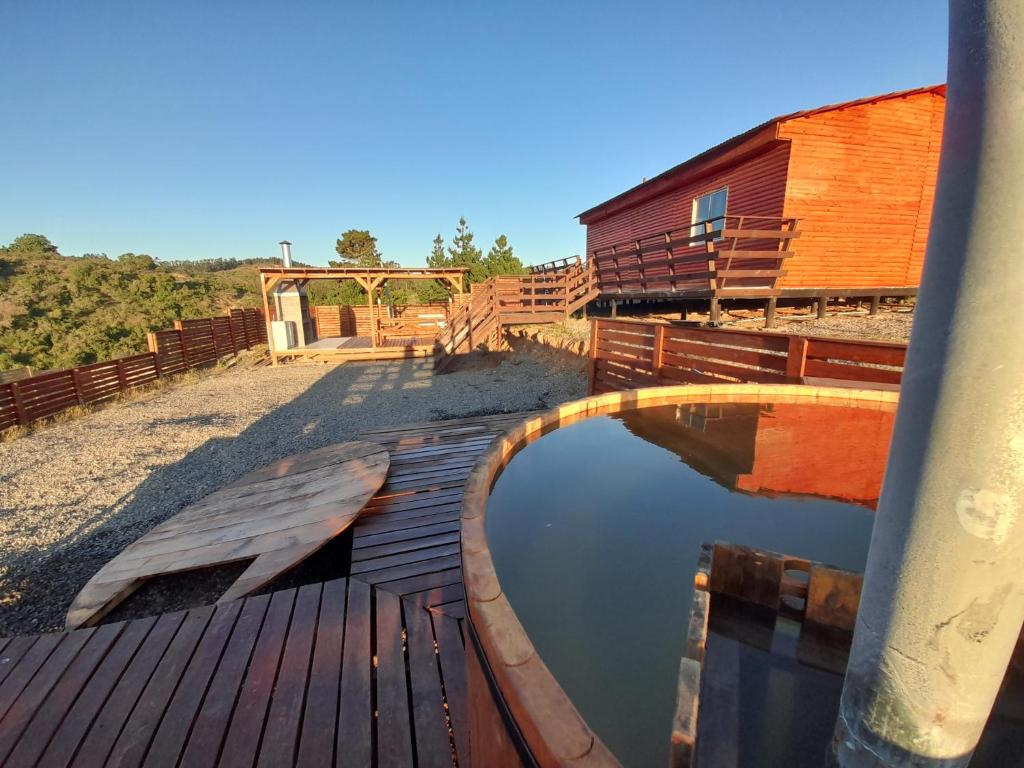 a pool of water on a wooden deck next to a building at Parcela fuentes in Cartagena