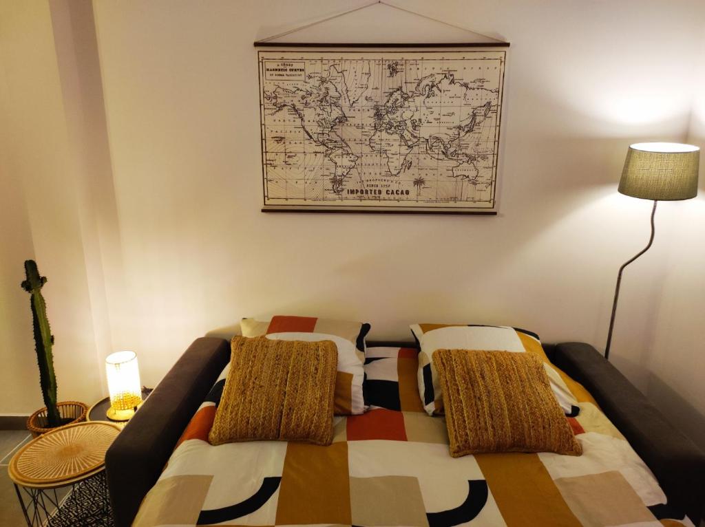 a bed in a room with a map on the wall at Cosy Studio à proximité de PARIS in Savigny-sur-Orge