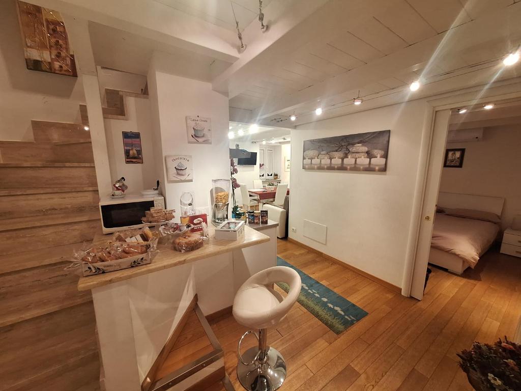 a living room with a counter and a room with a bed at Casa Garofoli in Frascati