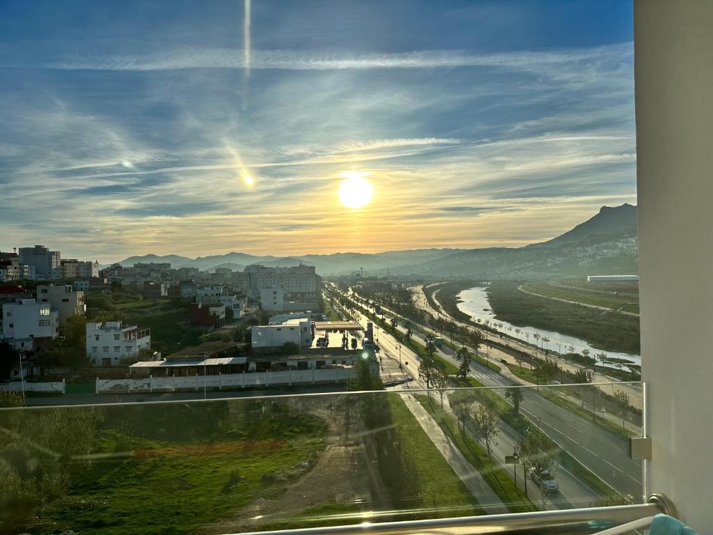 a view of a city with the sun in the sky at Riverside 2 in Tétouan