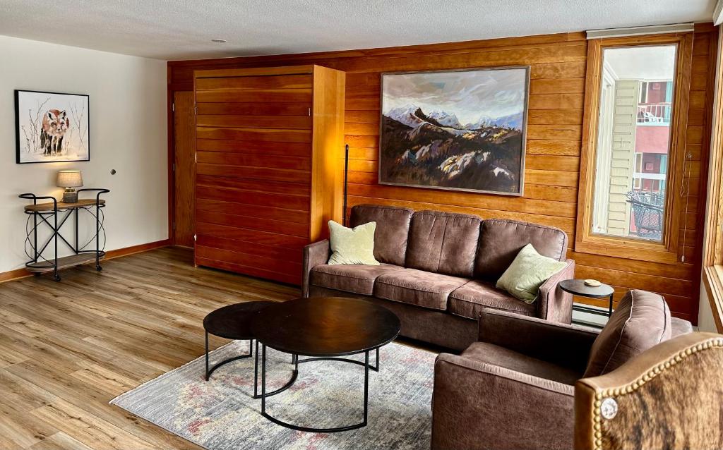 a living room with a couch and a table at Keystone Lakeside Condo in Keystone