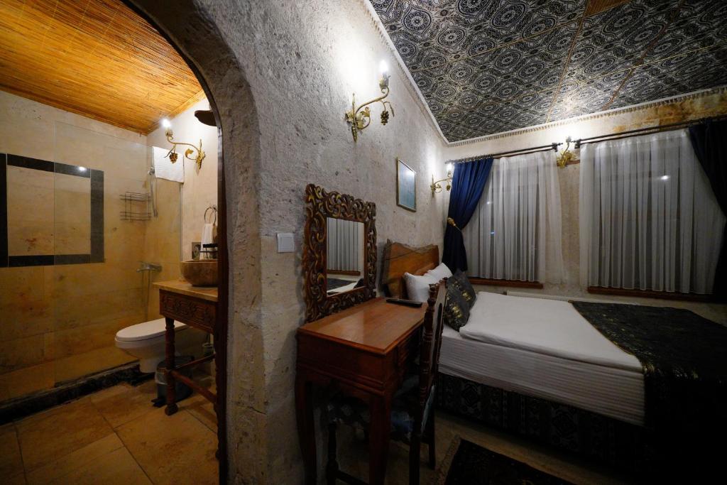 A bed or beds in a room at Cappadocia Nar Cave House & Swimming Pool