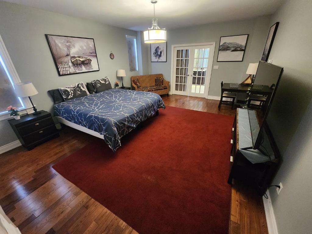 a bedroom with a bed and a red rug at Heart of Toronto Home in Toronto