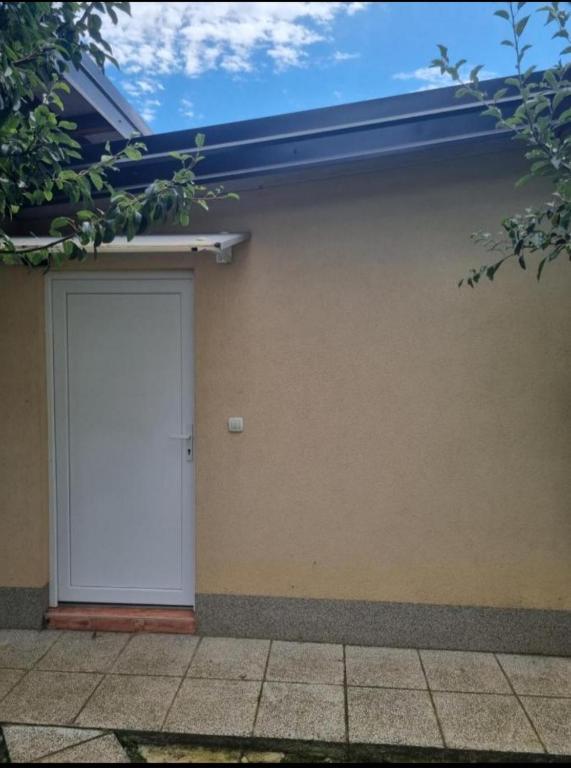 a garage with a white door on a building at APARTMAN SARAJEVO DVOKREVETNI-dvije osobe in Sarajevo