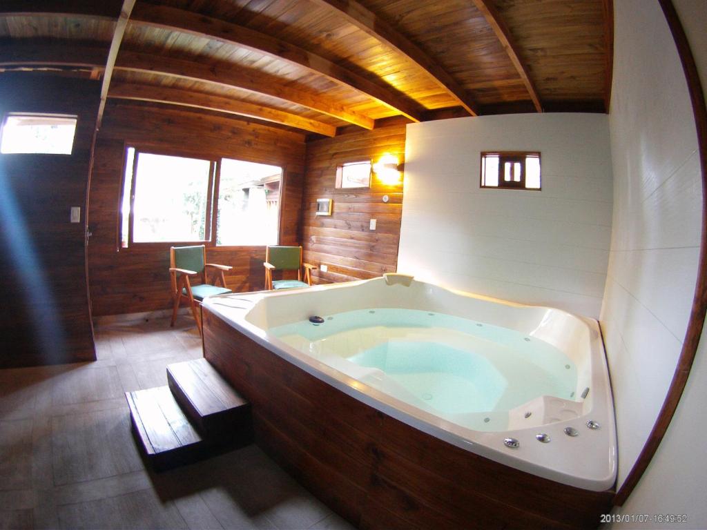 a large bath tub in the middle of a room at Cabañas Bosque El Ocio in Mar del Plata