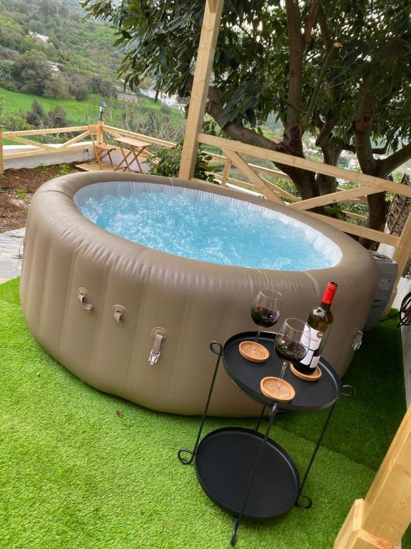 a pool with a table and two glasses of wine at Casa luliche in Las Palmas de Gran Canaria