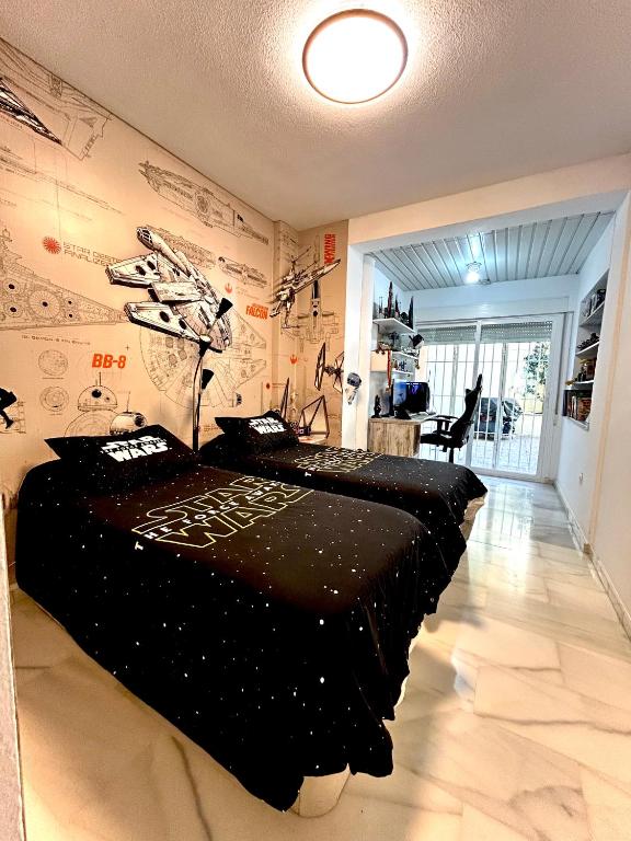 a bedroom with a black bed in a room at Casa Caracol in La Herradura