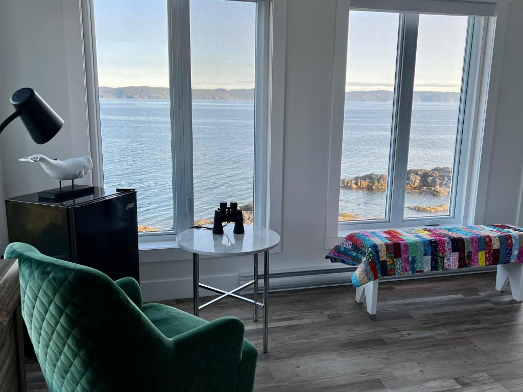 a living room with a view of the water at The View suites and breakfast in Triton, Newfoundland in Pilleyʼs Island