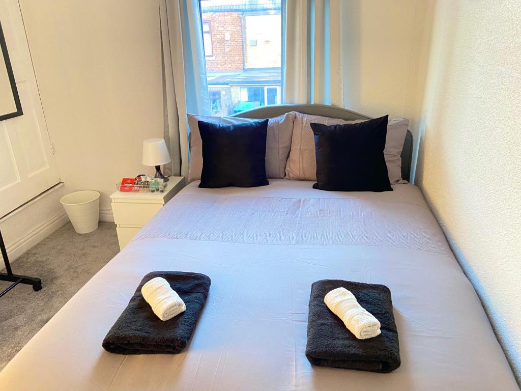 a bedroom with a bed with two towels on it at Kisobi Home Bedroom 2 in Hull