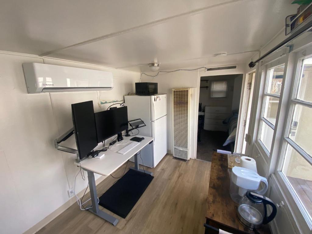 a room with a desk with a computer on it at Midtown Charm: 1BR Urban Pad in Reno