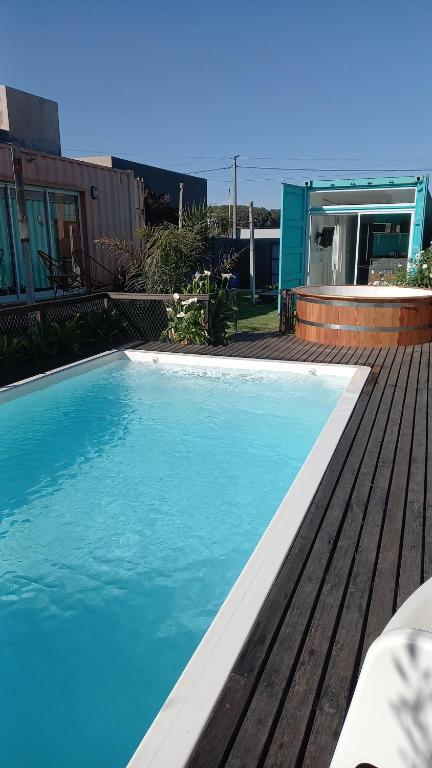 a large blue swimming pool next to a house at Casacubo Necochea in Necochea