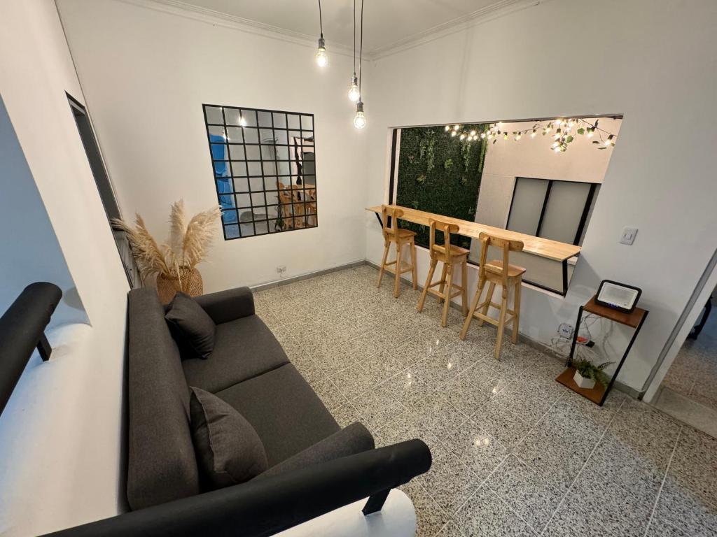 ein Wohnzimmer mit einem Sofa und einem Tisch in der Unterkunft Rustik House in Medellín