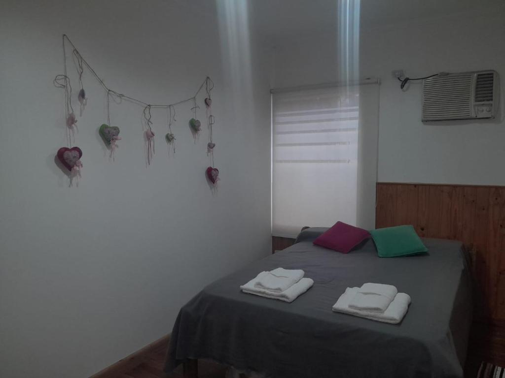 a bedroom with a bed with two towels on it at Depto Libres# in Paso de los Libres