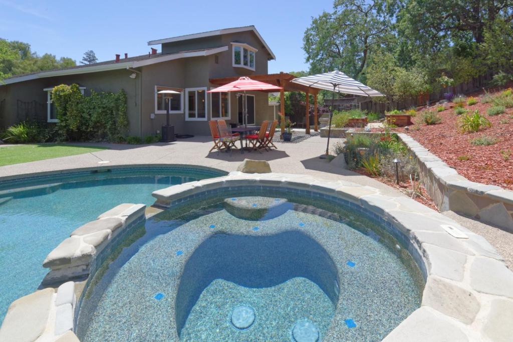 a swimming pool in front of a house at Gorgeous! Nicest Part of San Jose, Almaden in San Jose