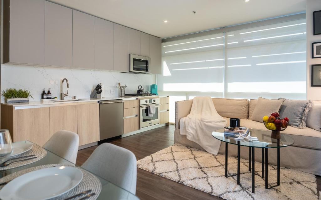 a kitchen and living room with a couch and a table at Stylish Condo By The Beach in Los Angeles