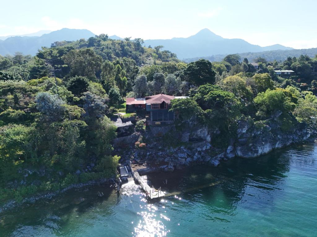 eine Luftansicht eines Hauses auf einer felsigen Insel in einem Fluss in der Unterkunft Amankaya Atitlan in Cerro de Oro