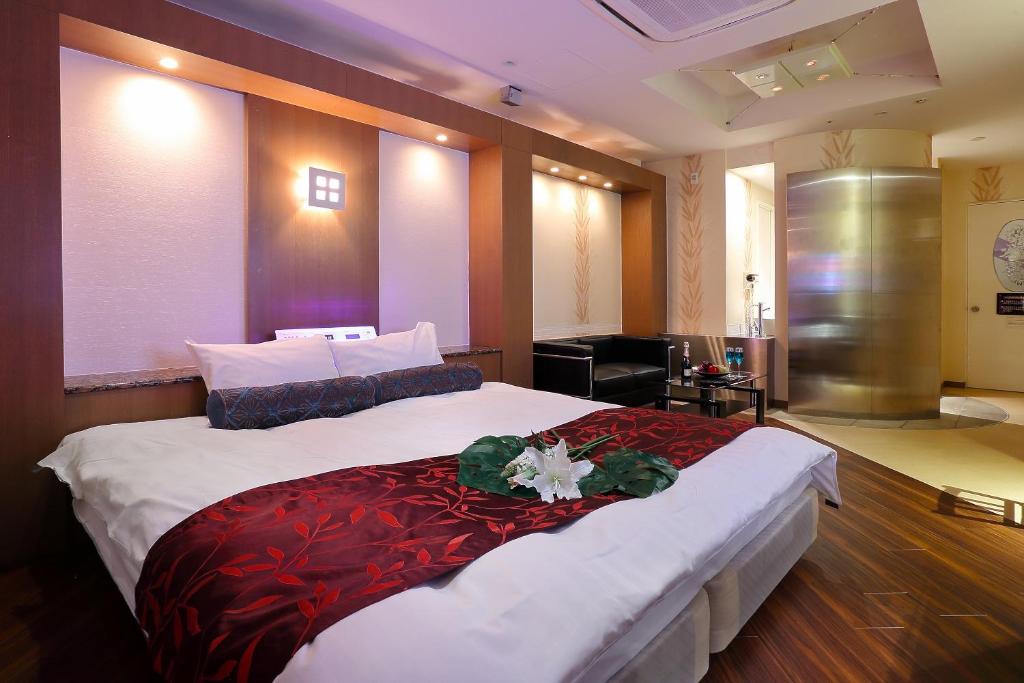 Ein Bett oder Betten in einem Zimmer der Unterkunft Hotel AXIS -アクシス-