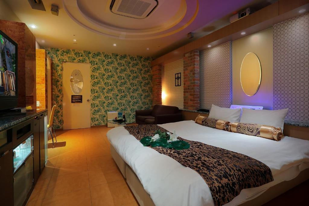Ein Bett oder Betten in einem Zimmer der Unterkunft Hotel AXIS -アクシス-